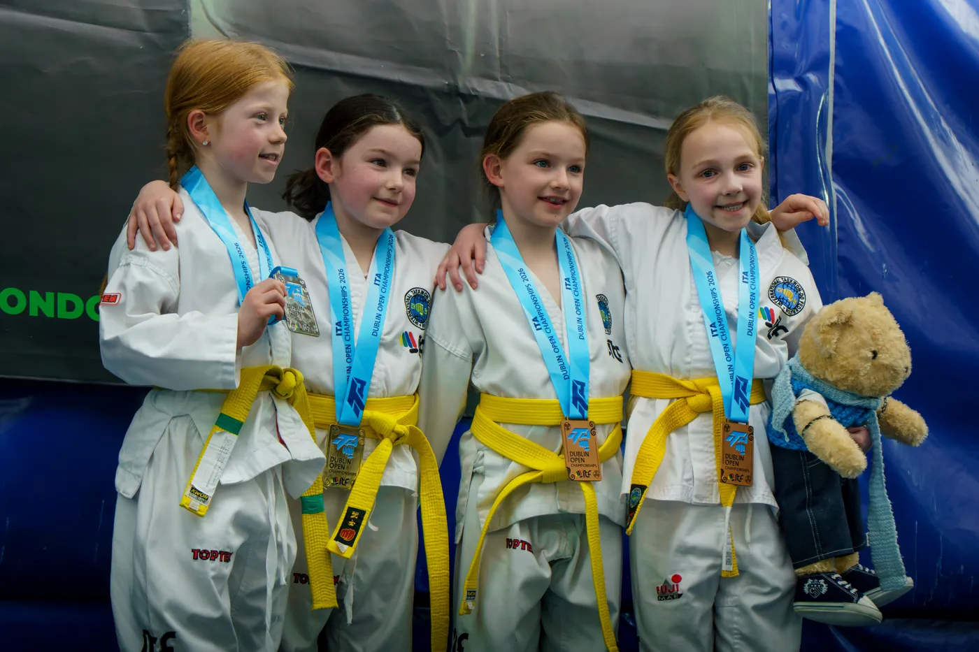 Group of young students wearing medals after competition
