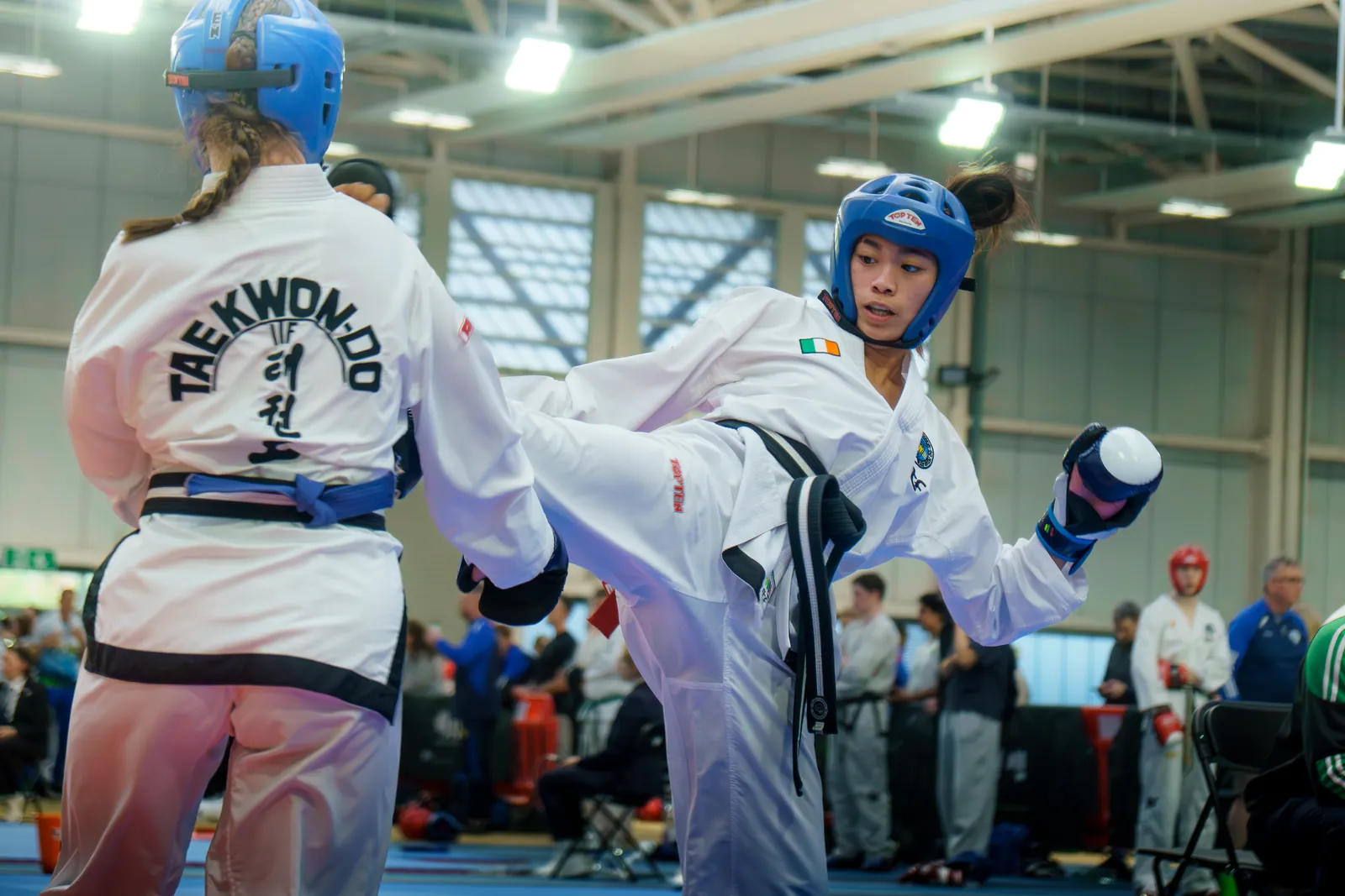 Two competitors exchanging techniques in a sparring bout